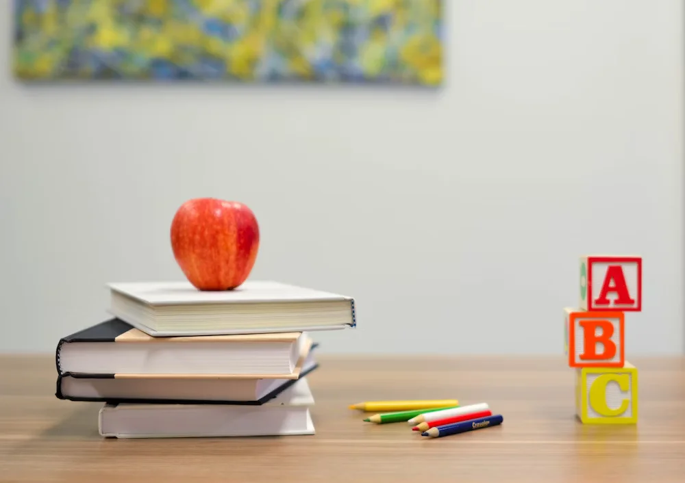 Red Apple Fruit On Four Pyle Books